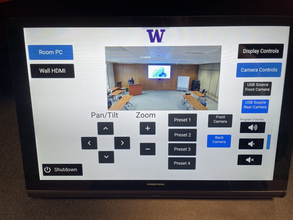 Crestron touch panel showing room, camera, and display controls